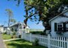 White cottages behind picket fences have views to the ocean.