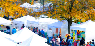 Images shows craft vendors tents at the annual free family-oriented fun Freeport Fall Festival